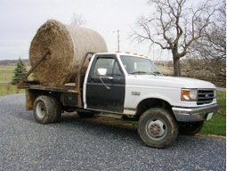 Jeanne's "hydrabed" four-wheel drive truck with a thousand pound hay bale on the back.