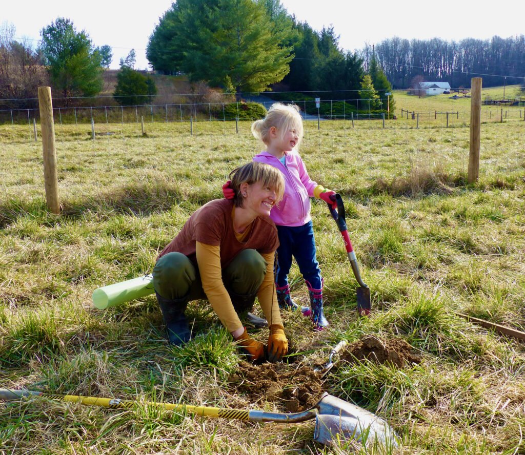 Hope for the earth. Mother and daughter planting trees.